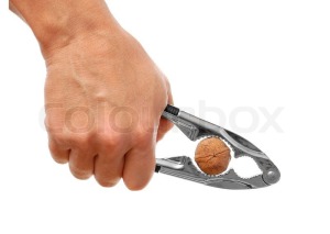 2009673-man-cracking-walnut-with-metal-nutcracker-in-hand-isolated-on-white-background